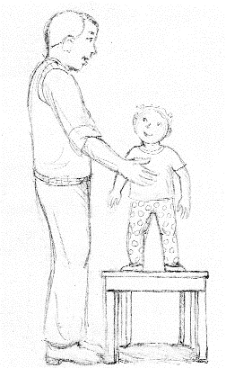 Pediatric posture examination with child elevated on stool