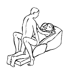 Partner-supported position using a wedge pillow for back pain relief