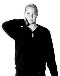 Woman performing standing neck stretch physical therapy exercise