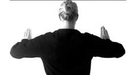 Woman performing wall slide shoulder mobility exercise