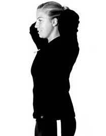 Woman performing standing neck extension physical therapy exercise